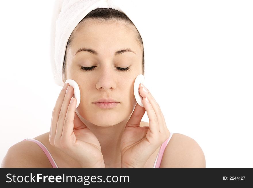 Young woman cleaning her face with cosmetic pads. Young woman cleaning her face with cosmetic pads