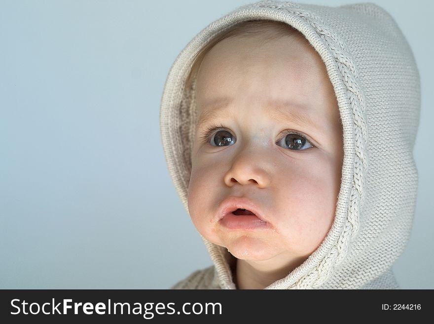 Image of cute baby wearing a hooded sweater. Image of cute baby wearing a hooded sweater