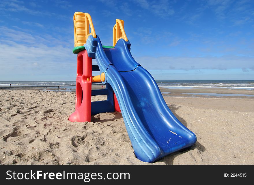 Plastic slide for small children on the beach. Plastic slide for small children on the beach