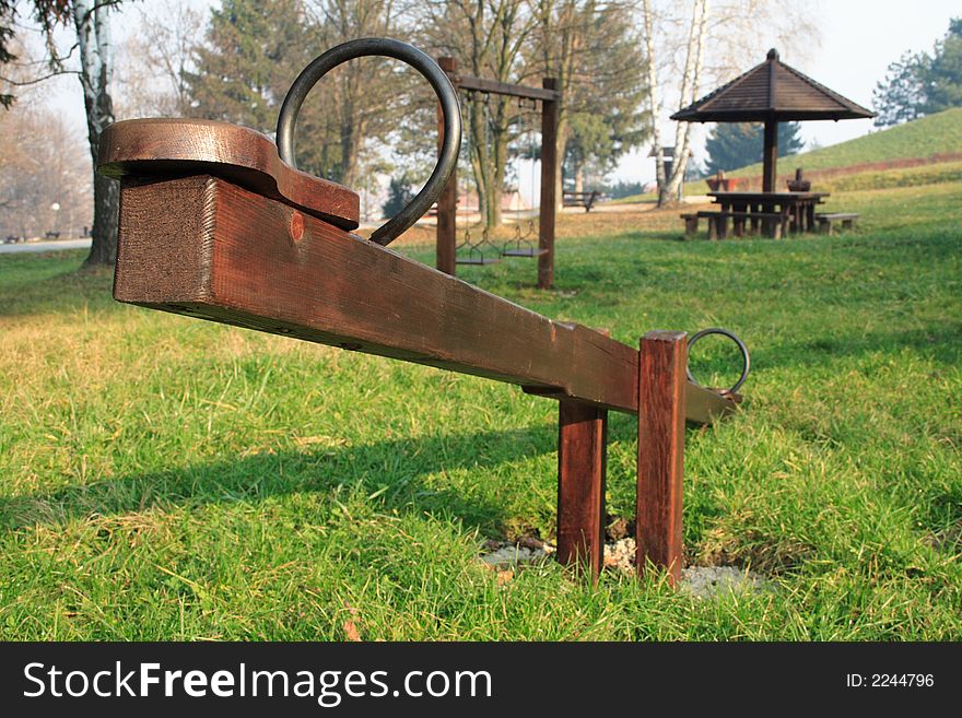 A wooden seesaw in a park