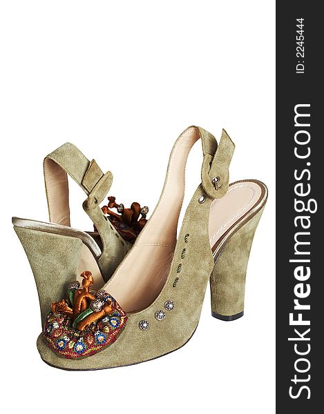 Suede female shoes with an ornament on a white background