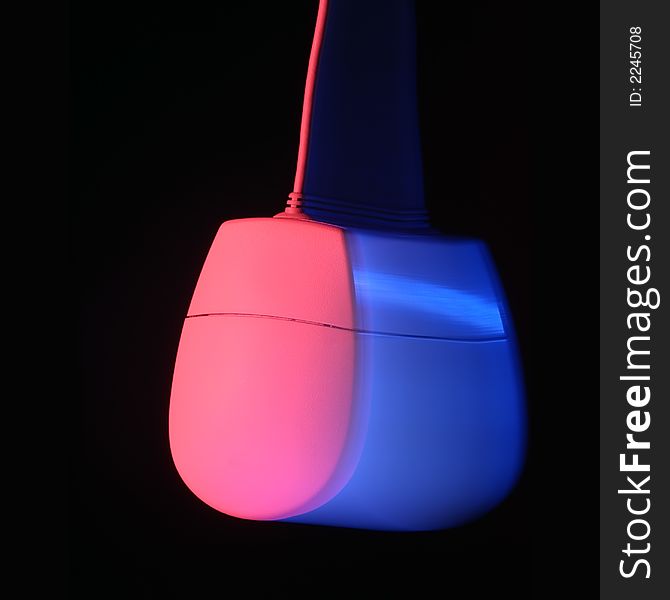 Swinging computer mouse with red and blue lighting showing movement. Swinging computer mouse with red and blue lighting showing movement.