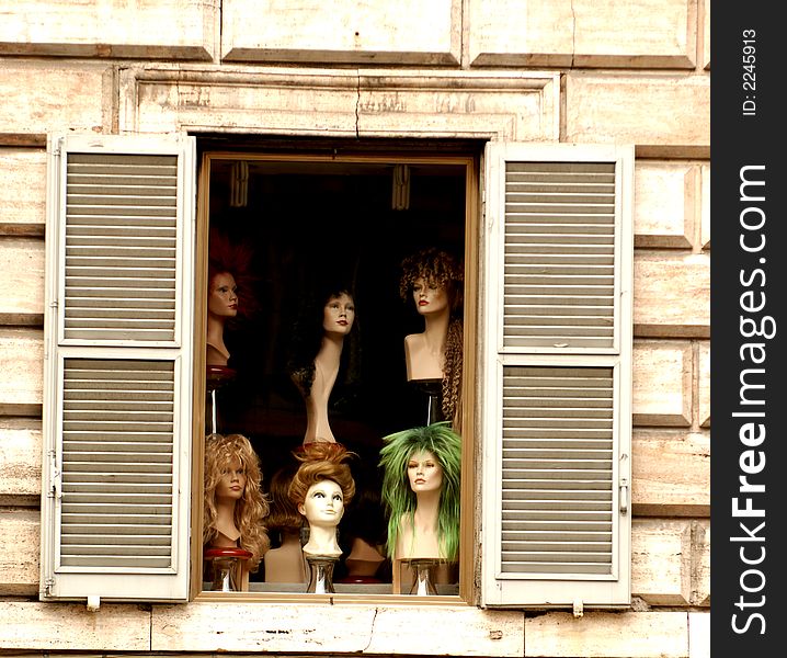 Mannequin heads in the Roma shop window. Mannequin heads in the Roma shop window