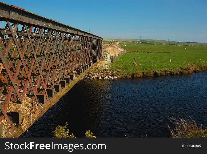 Iron railway bridge with the tracks visible the other side of it on a single track rural railway network. Iron railway bridge with the tracks visible the other side of it on a single track rural railway network.