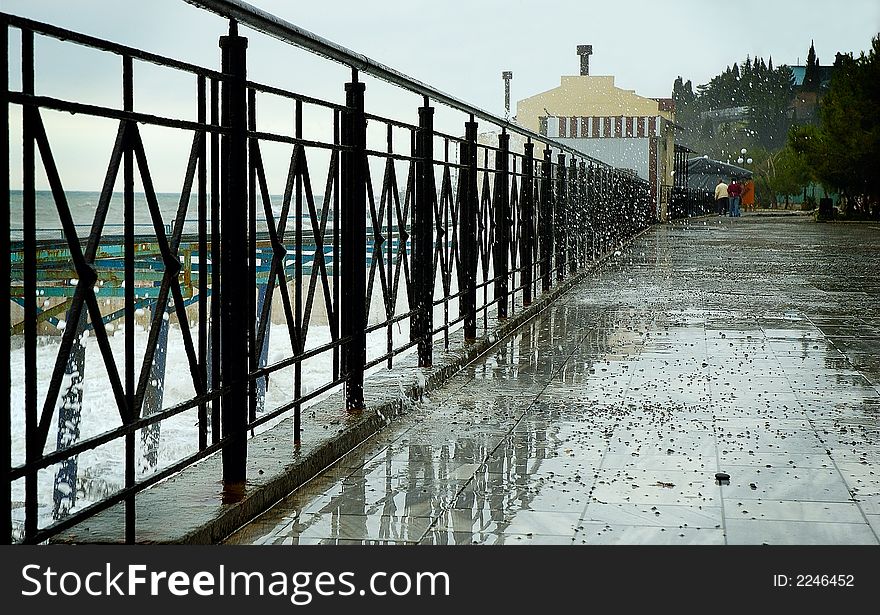 Few people walking by the sea front. Few people walking by the sea front