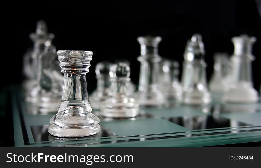 Glass Chess Pieces on a Frosted Glass Chess Board. Glass Chess Pieces on a Frosted Glass Chess Board