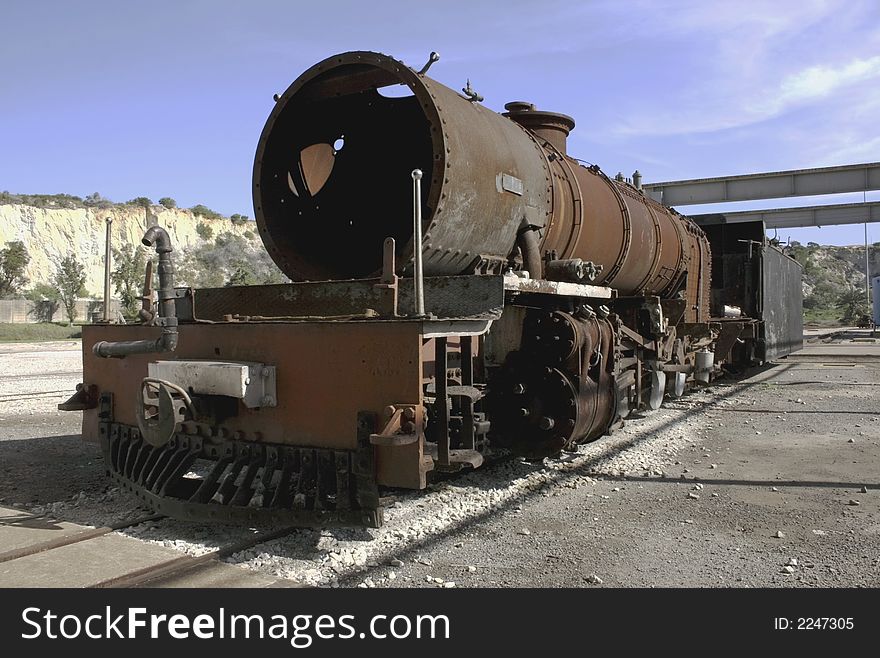 Outmoded steam engine in railroad yard. Outmoded steam engine in railroad yard