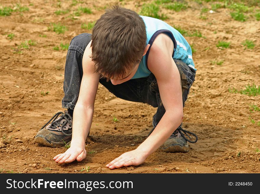 Boy Playing In The Dirt