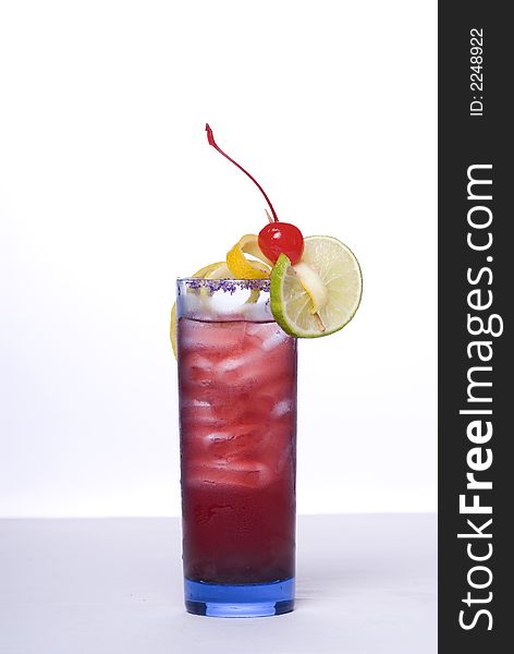 Colorful alcoholic cocktail in a tall glass against white background. Colorful alcoholic cocktail in a tall glass against white background