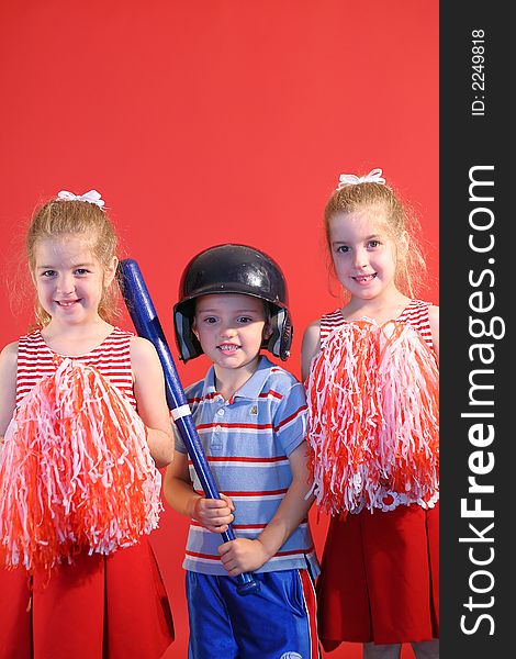 Shot of a baseball boy & cheerleaders vertical