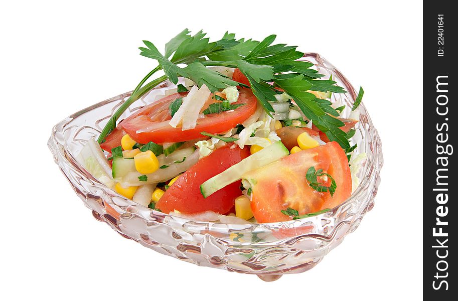 Vegetable salad with tomatoes and parsley in a glass bowl