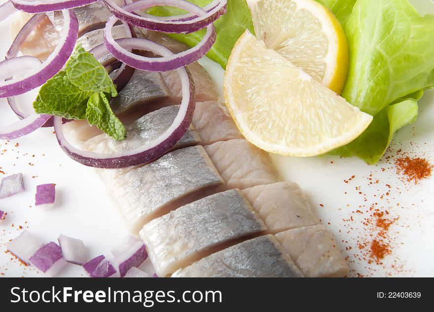 Portion of typical Dutch herring on the plate and on white Background. Portion of typical Dutch herring on the plate and on white Background