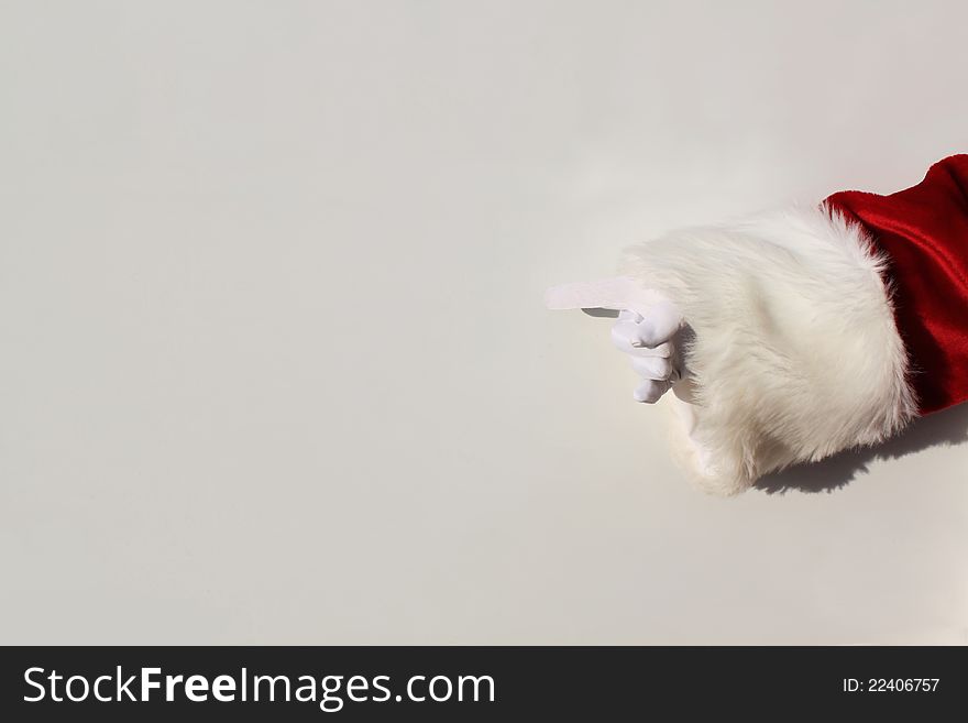 Santa's gloved hand pointing to a blank sign.  Write your own message. Santa's gloved hand pointing to a blank sign.  Write your own message.