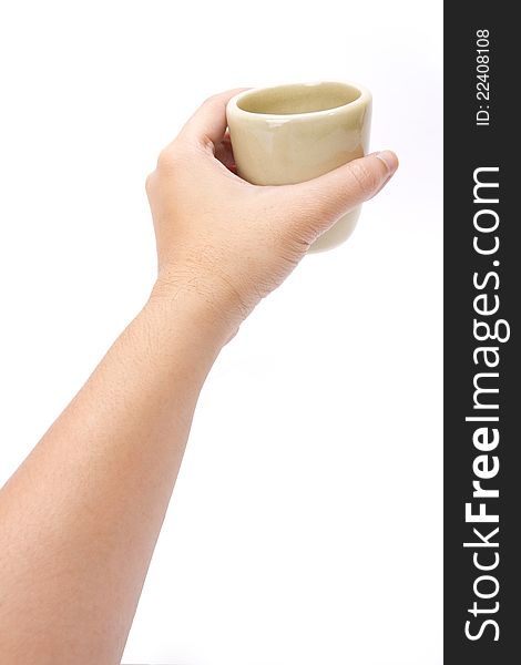 Male hand holding Japanese green tea cup.