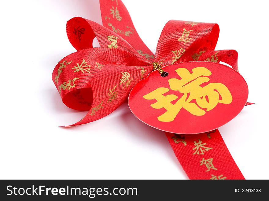 Red bow and Chinese alphabet on white background