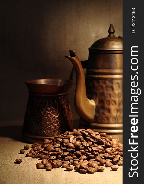 Vintage still life with heap of coffee beans near old copper coffeepot. Vintage still life with heap of coffee beans near old copper coffeepot