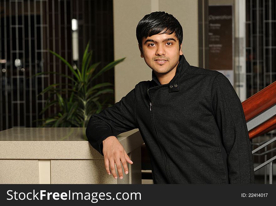 Eastern College Student smiling inside a college building. Eastern College Student smiling inside a college building