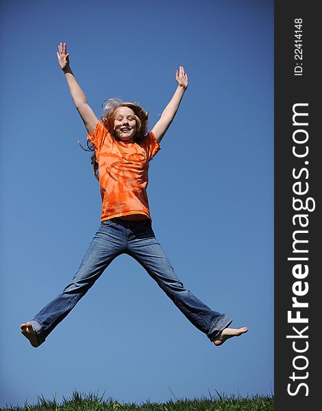 Young Girl Jumping against a blue sky. Young Girl Jumping against a blue sky