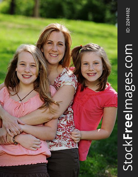 Mother and Daughters portrait outdoors on a sunny day