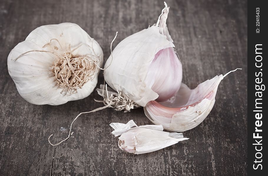 Close up image of garlic on rough chopping board