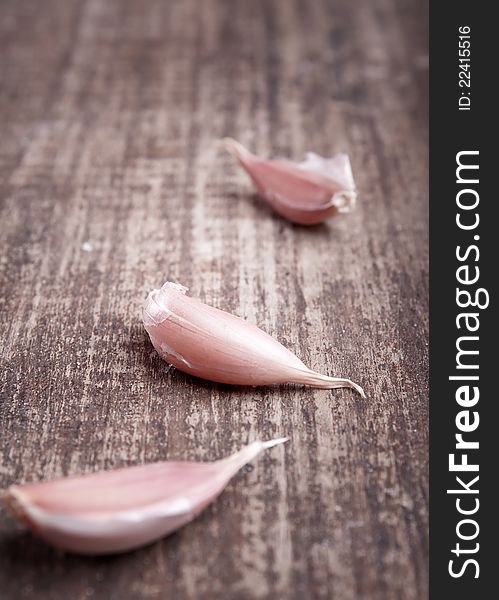 Garlic pieces on the wooden plank