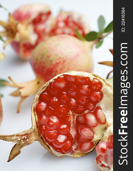 Forefront of a pomegranate pieces on a white