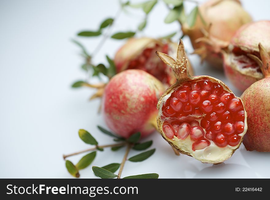 Forefront of a pomegranate pieces on a white