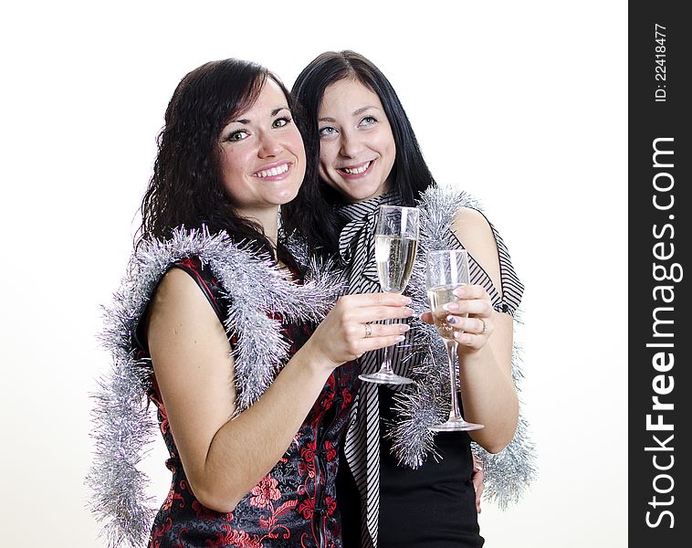 Christmas or new year: two girls congratulates with glasses of wine