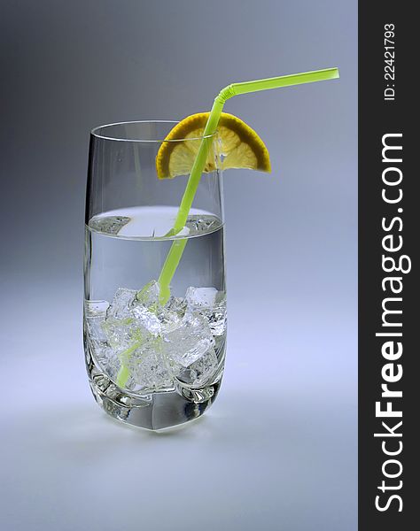 Glass of cold water with ice cubes and lemon slice. Glass of cold water with ice cubes and lemon slice