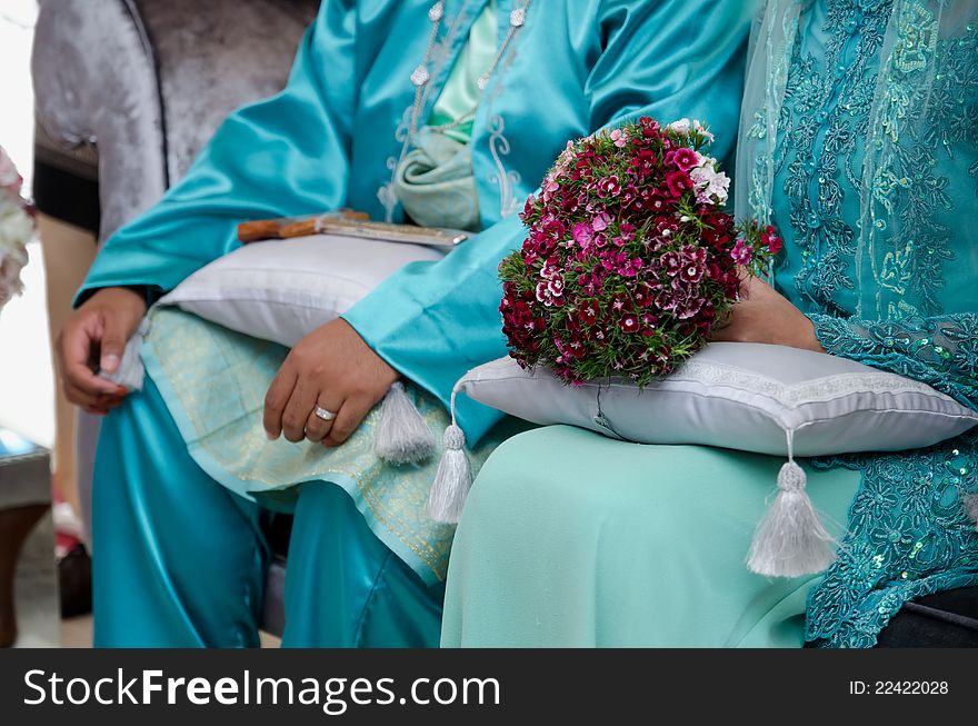 A bride's hand holding a bouquet of flower on wedding day. A bride's hand holding a bouquet of flower on wedding day