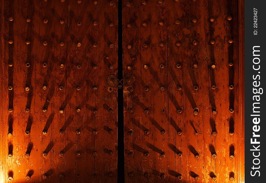 An ancient Chinese wooden door by night.