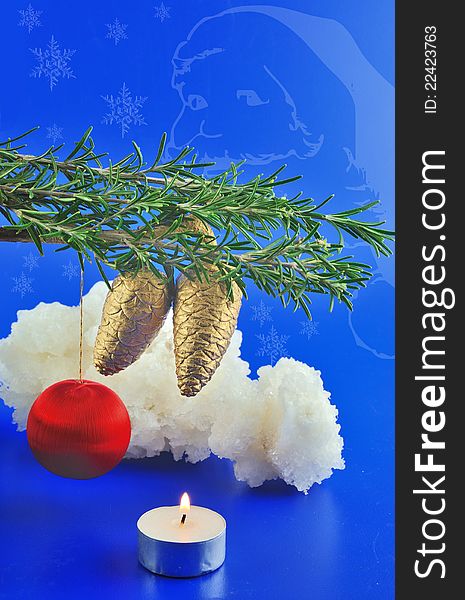 Red balls, cone spruce, ice and sprigs to decorate and candles burning for Christmas, against a blue background. Red balls, cone spruce, ice and sprigs to decorate and candles burning for Christmas, against a blue background