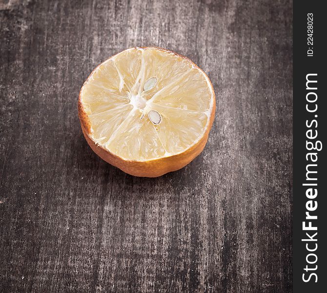 Dried lemon on old wooden plank