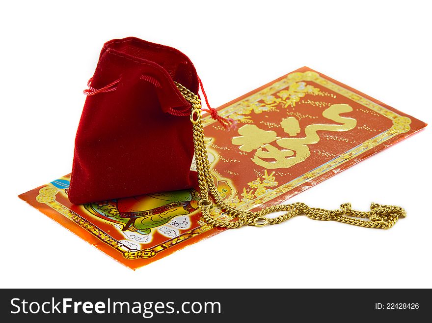 Golden necklace in red bag and Blessing word. Golden necklace in red bag and Blessing word