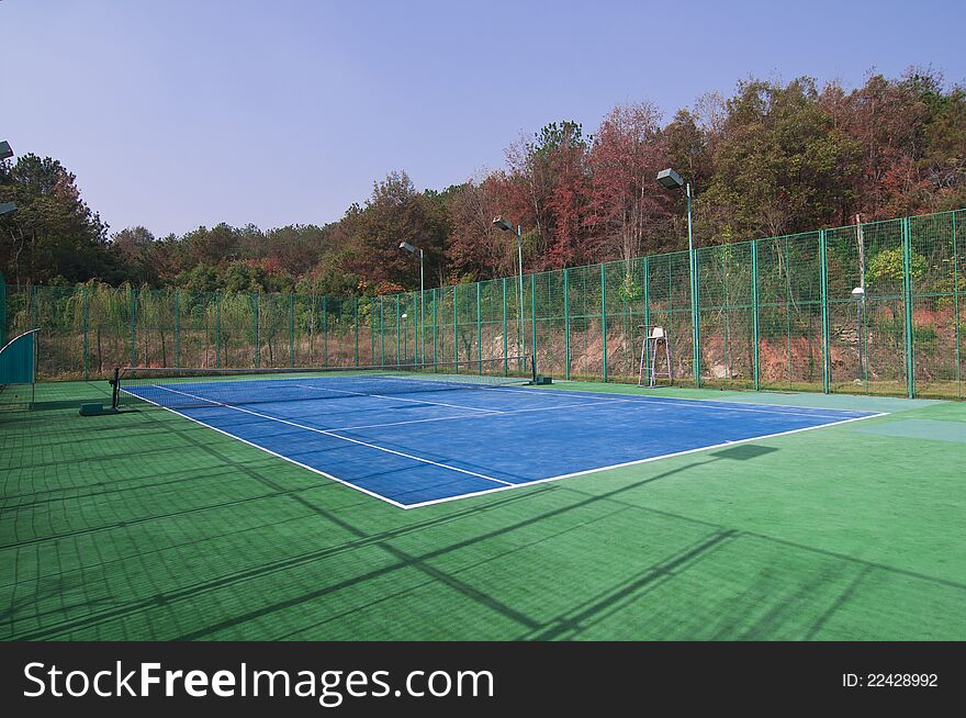 Empty tennis courts, net and lines, wideangle from center. Empty tennis courts, net and lines, wideangle from center