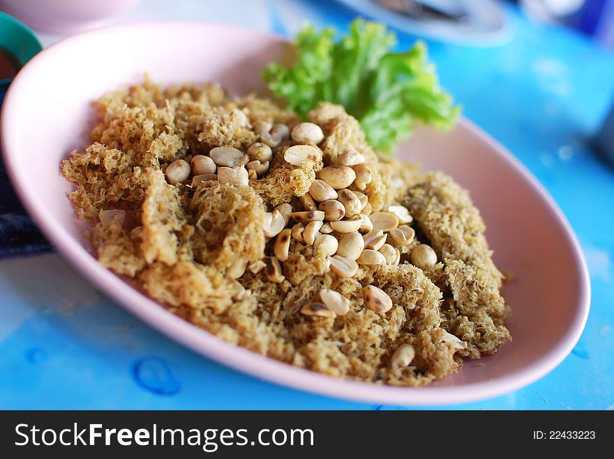 Spicy salad of fried minced fish , Asian style food in Thailand