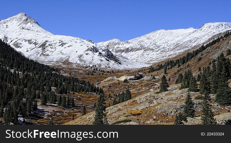 Distant mine in winter Colorado mountain valley
