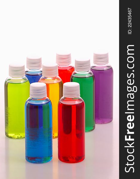 Test bottles of colorful chemicals on white. Test bottles of colorful chemicals on white
