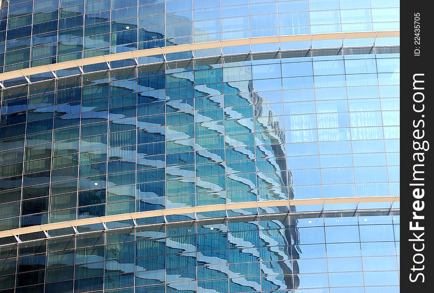 Reflections on office building blue glass wall. Reflections on office building blue glass wall