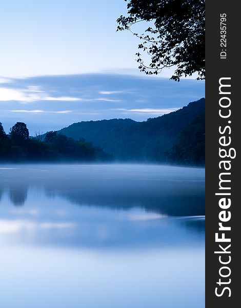 The Dordogne river in the mist at dawn, Dordogne, France. The Dordogne river in the mist at dawn, Dordogne, France.