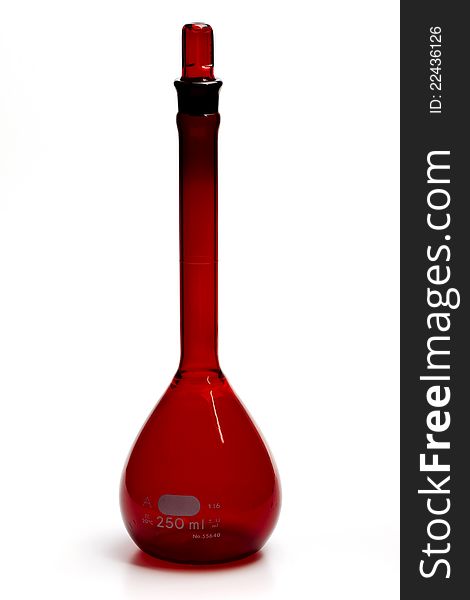 Red volumetric flask on the white background