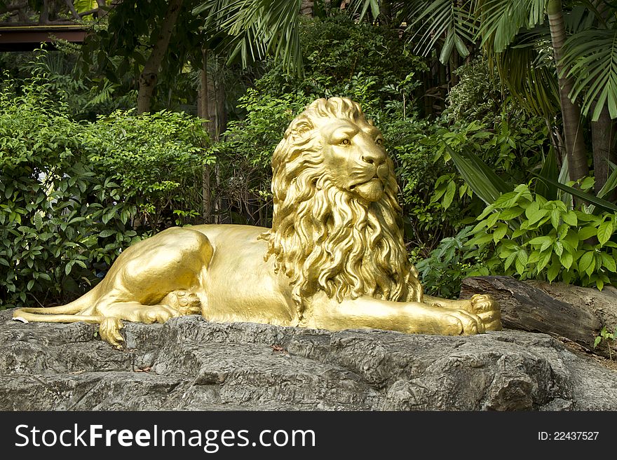 Golden lion statue in park
