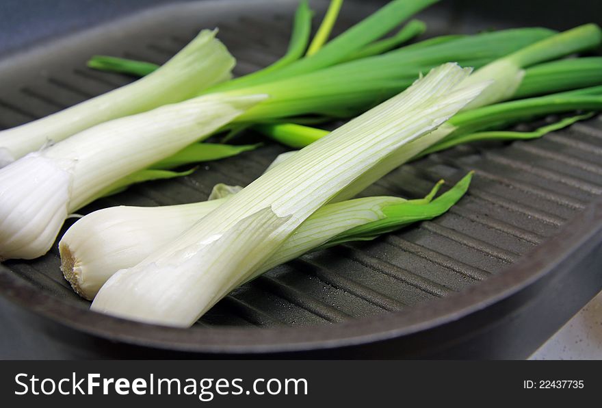 Colorful spring onion on a griddle. Colorful spring onion on a griddle