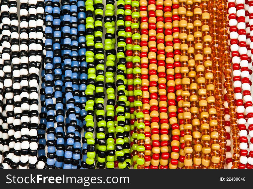 Different coloured glass beads hanging in a row