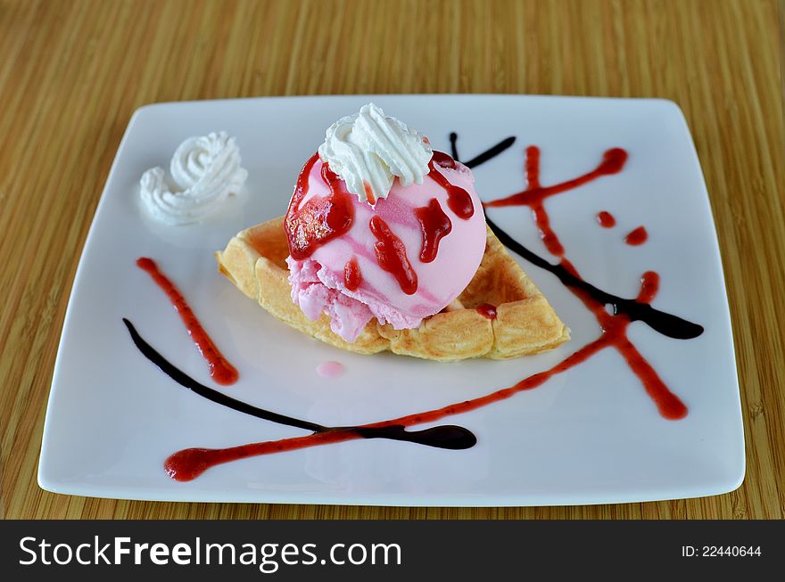 Waffle and whipping cream with strawberry ice cream. Waffle and whipping cream with strawberry ice cream