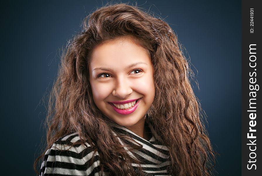 Portrait of beautiful smiling girl  on blue background