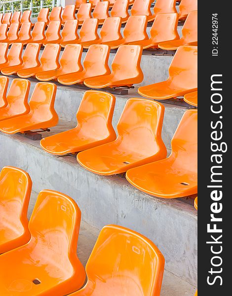 Sheer orange seats arranged in a row. Sheer orange seats arranged in a row.