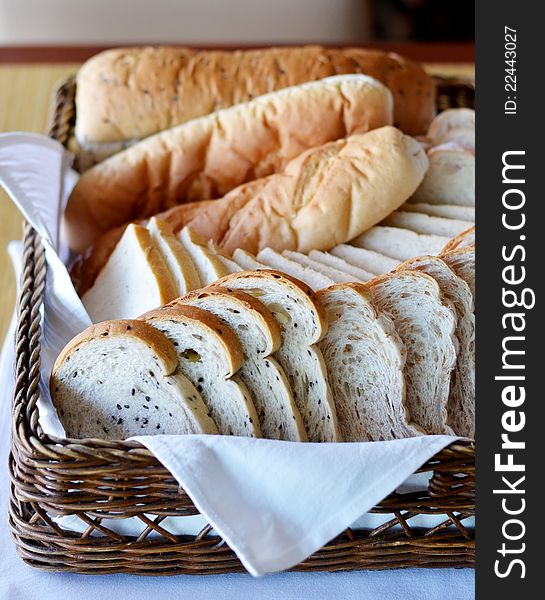 Arrangement of bread in basket on table. Arrangement of bread in basket on table