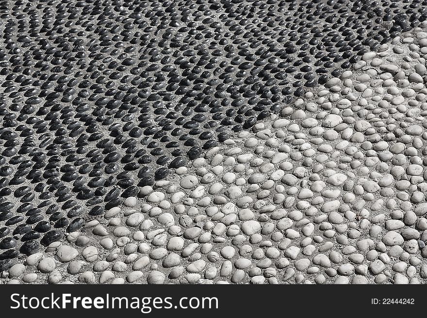 Grey and black stones on the ground dividing space in two parts