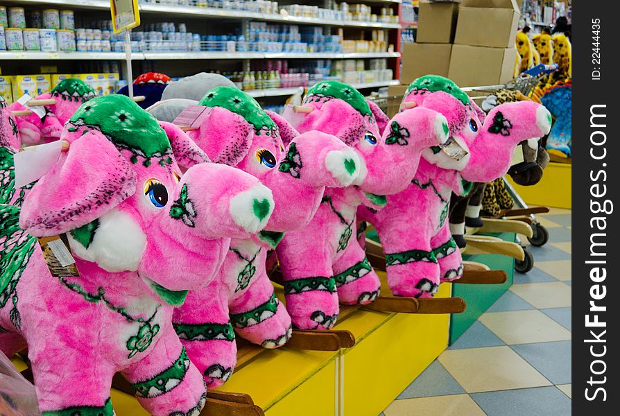 Soft toy - a pink elephant on a supermarket counter